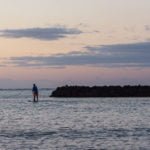 Lone paddleboarder his way out