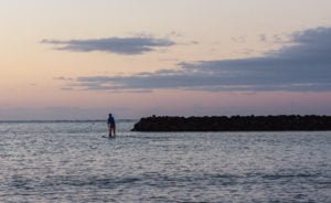 Lone paddleboarder his way out