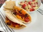 Tortizzas served with a small cucumber-tomato salad